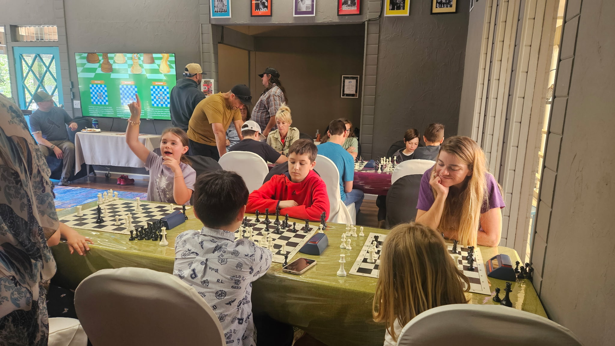 Kids and adults playing chess at Carmel Valley Chess Club grand opening