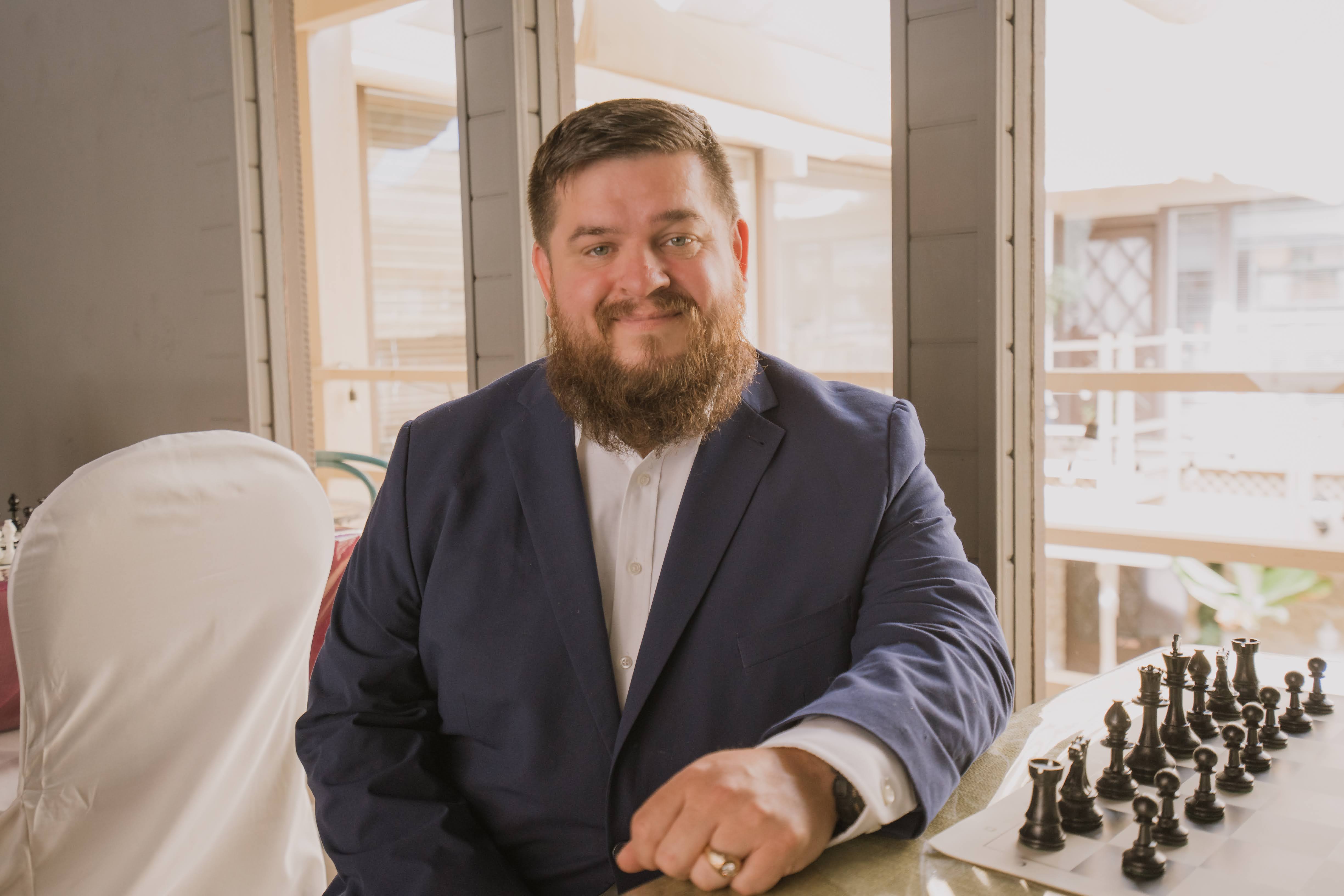 Coach JB smiling at Carmel Valley Chess Club