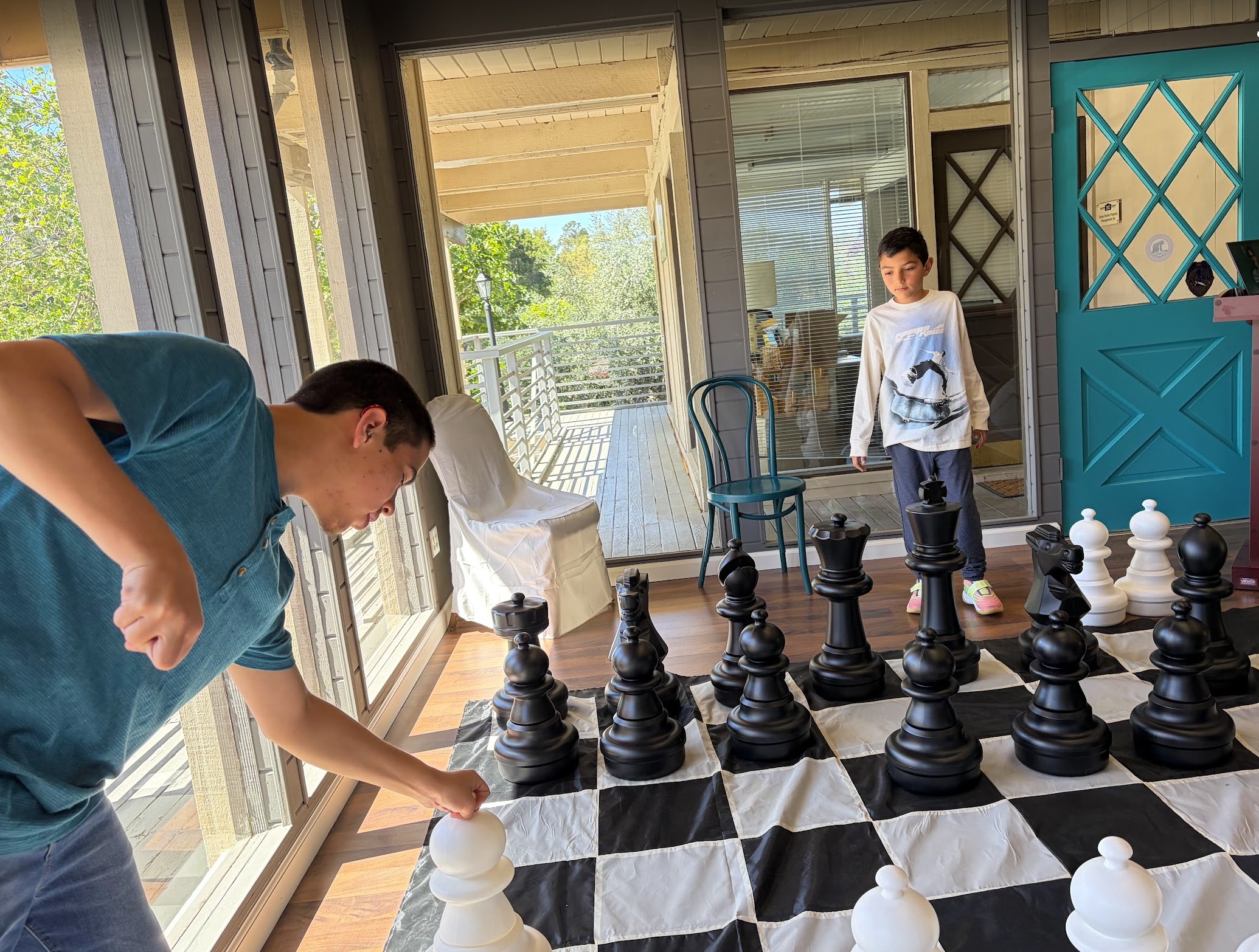 Kids playing giant chess at Carmel Valley Chess Club