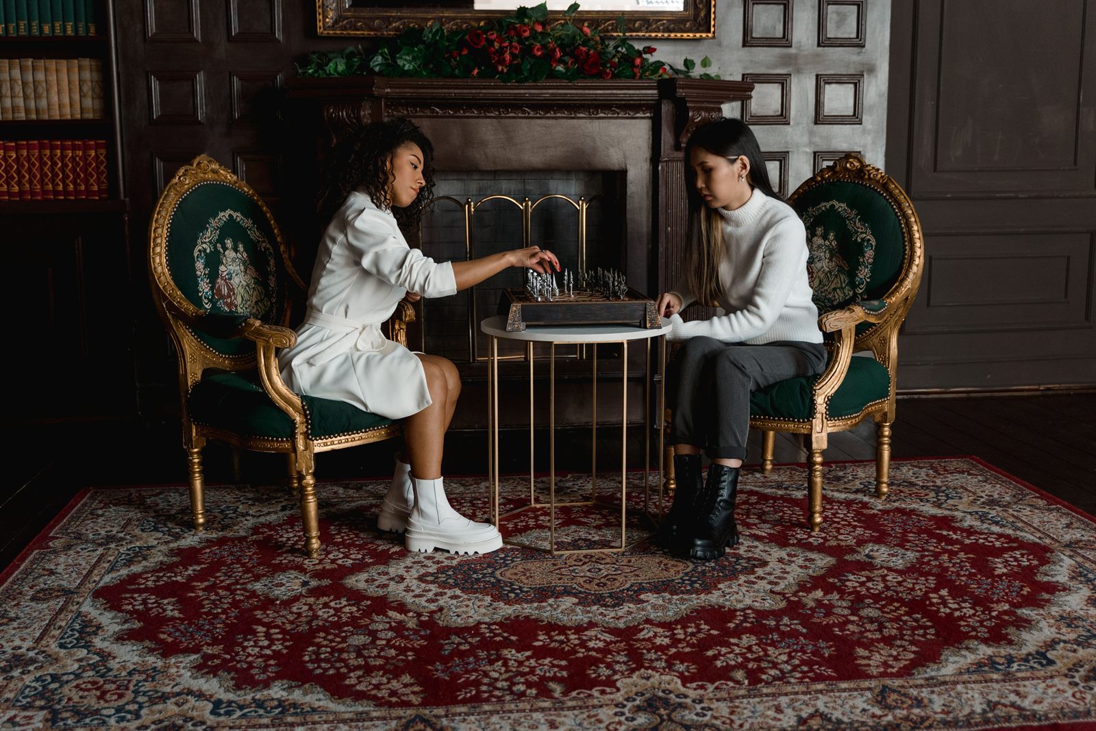 Two women playing chess — promoting the Carmel Valley Chess Club women's chess night