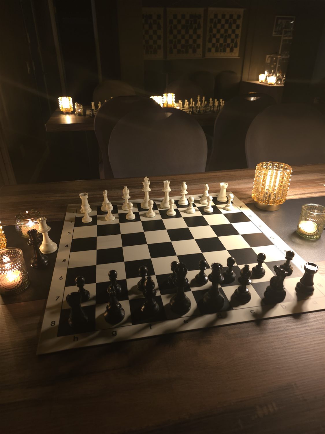 A candlelit chessboard ready for play